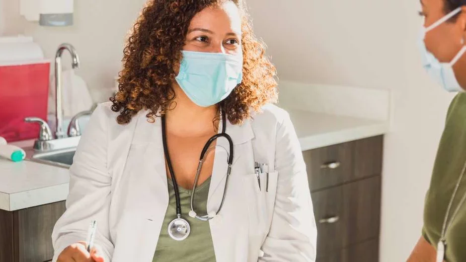 Photo of makes Dr and Patient interacting in a physician's room